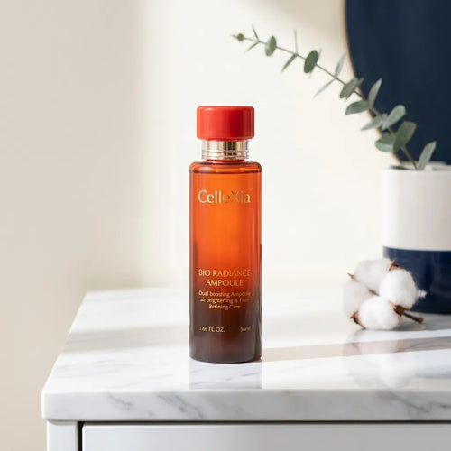 Lifestyle — Celecia Bio Radiance Ampoule on a marble shelf with botanicals, soft natural light