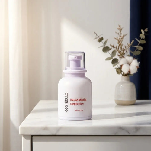 Lifestyle — Combellure Brightening Complex Serum on a marble vanity, soft morning light